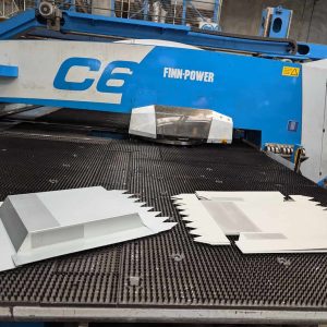 Completed metal components after turret punching and bending, showing advanced sheet metal fabrication and forming capabilities